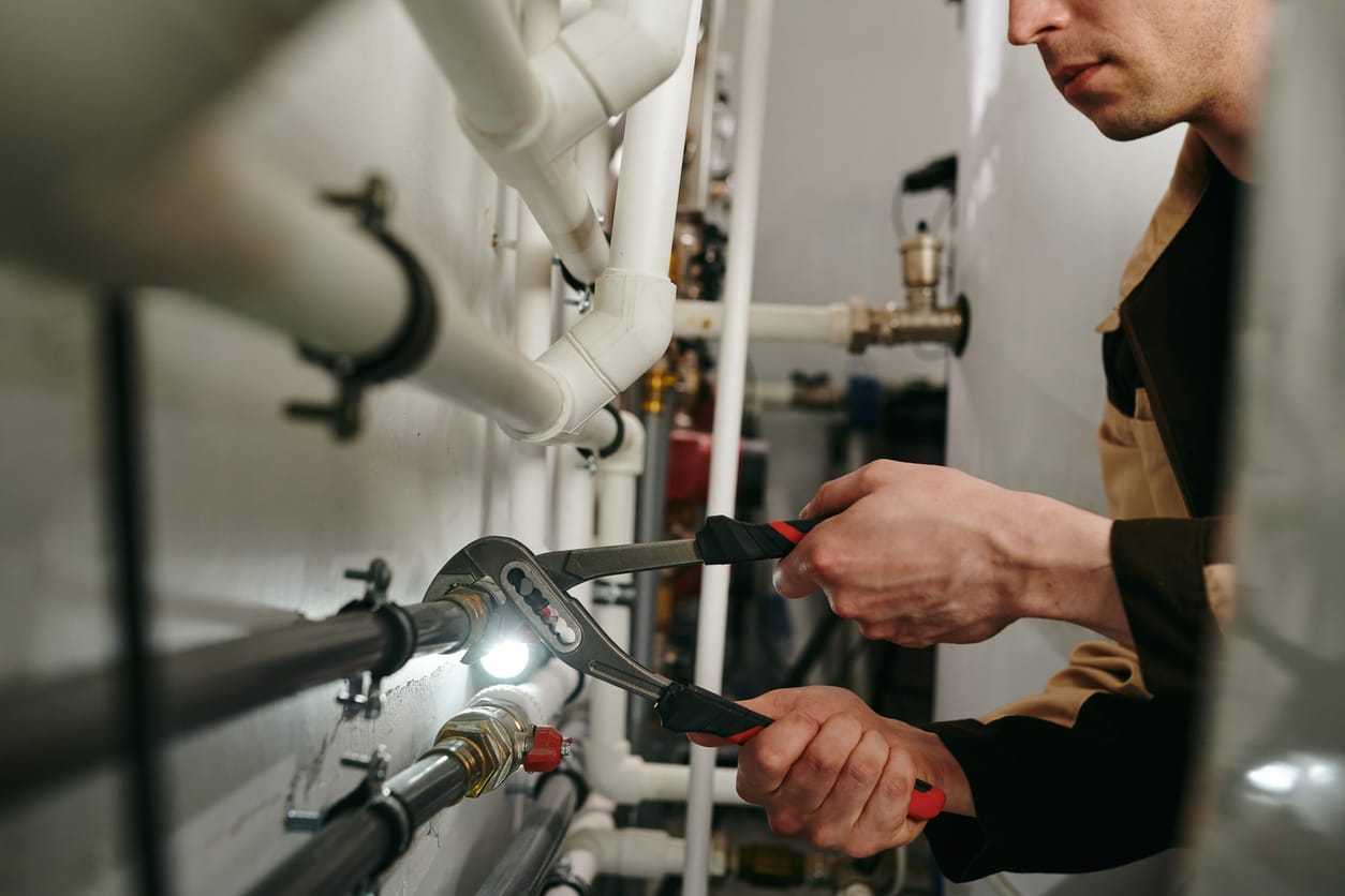 Plumbers maintaining commercial plumbing pipes in Ormond Beach