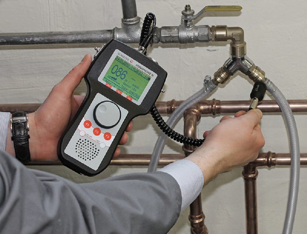 Plumber testing pipes with electronic leak detection equipment in Ormond Beach