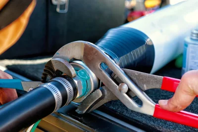 Technician tightening an industrial pipe connection in Ormond Beach