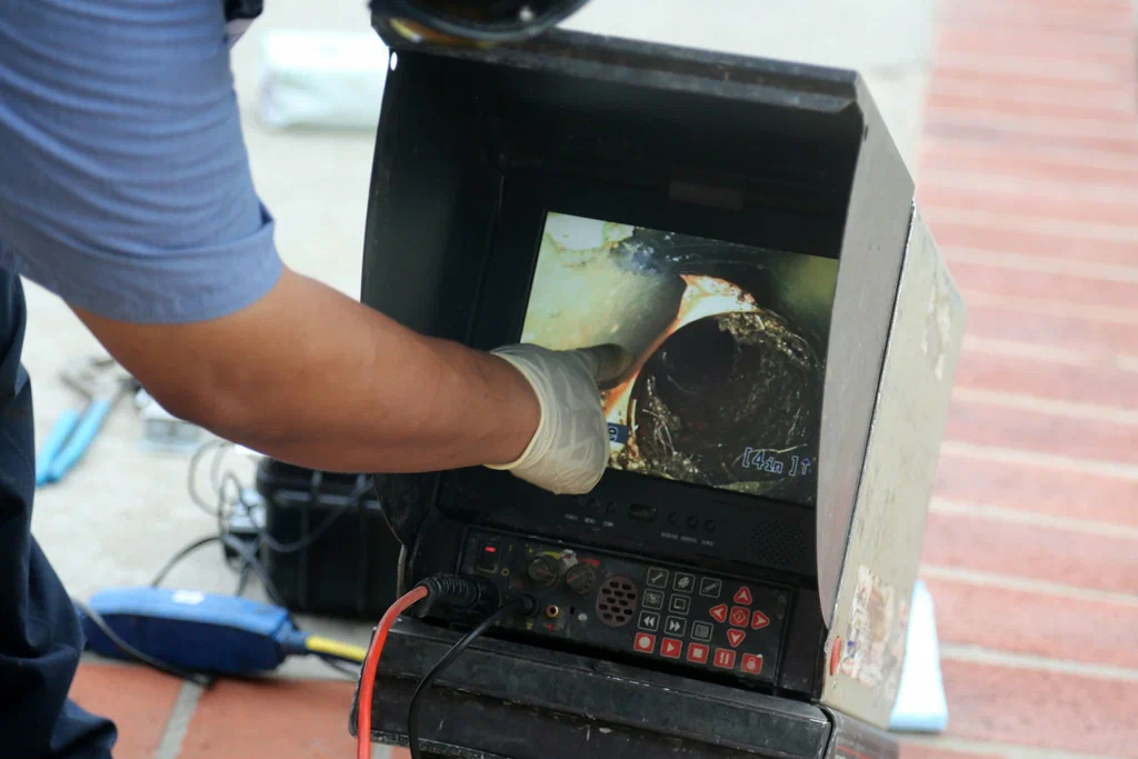 Technician viewing a drain inspection camera in Ormond Beach
