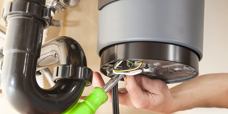 Technician repairing the heating element of a water heater in Ormond Beach