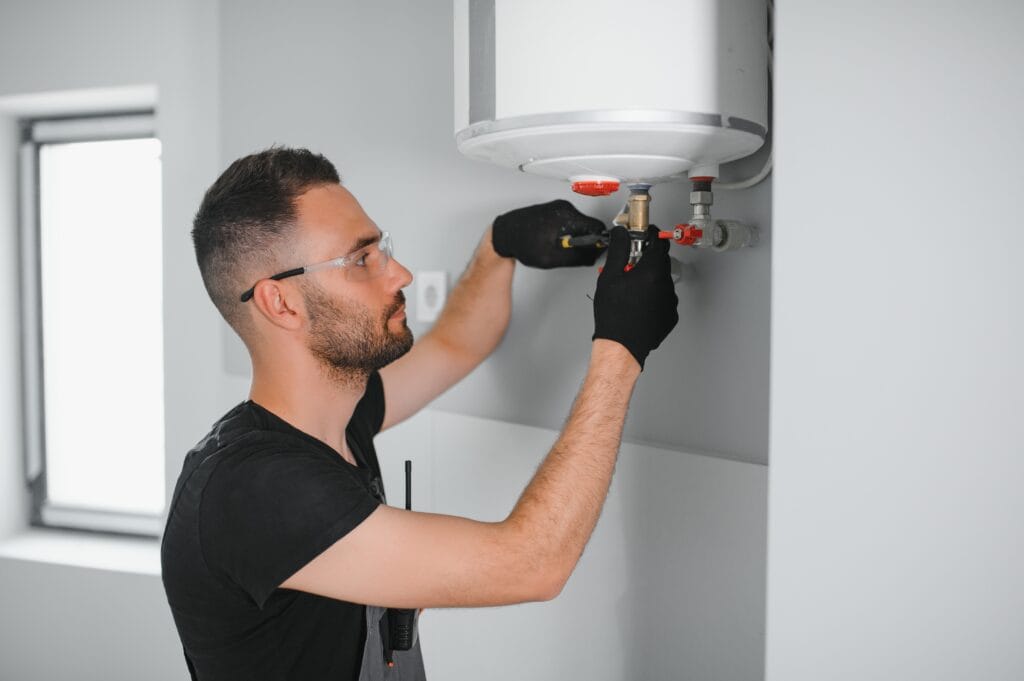 Technician performing water heater maintenance in Ormond Beach