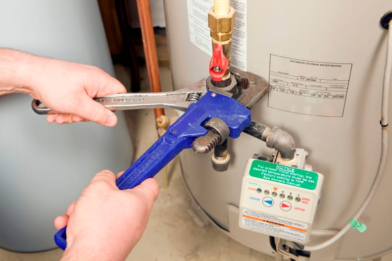 Plumber repairing a water heater valve in Ormond Beach